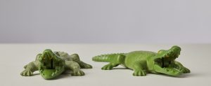 Two Playmobil toy crocodiles in green plastic. Their jointed mouths are open.